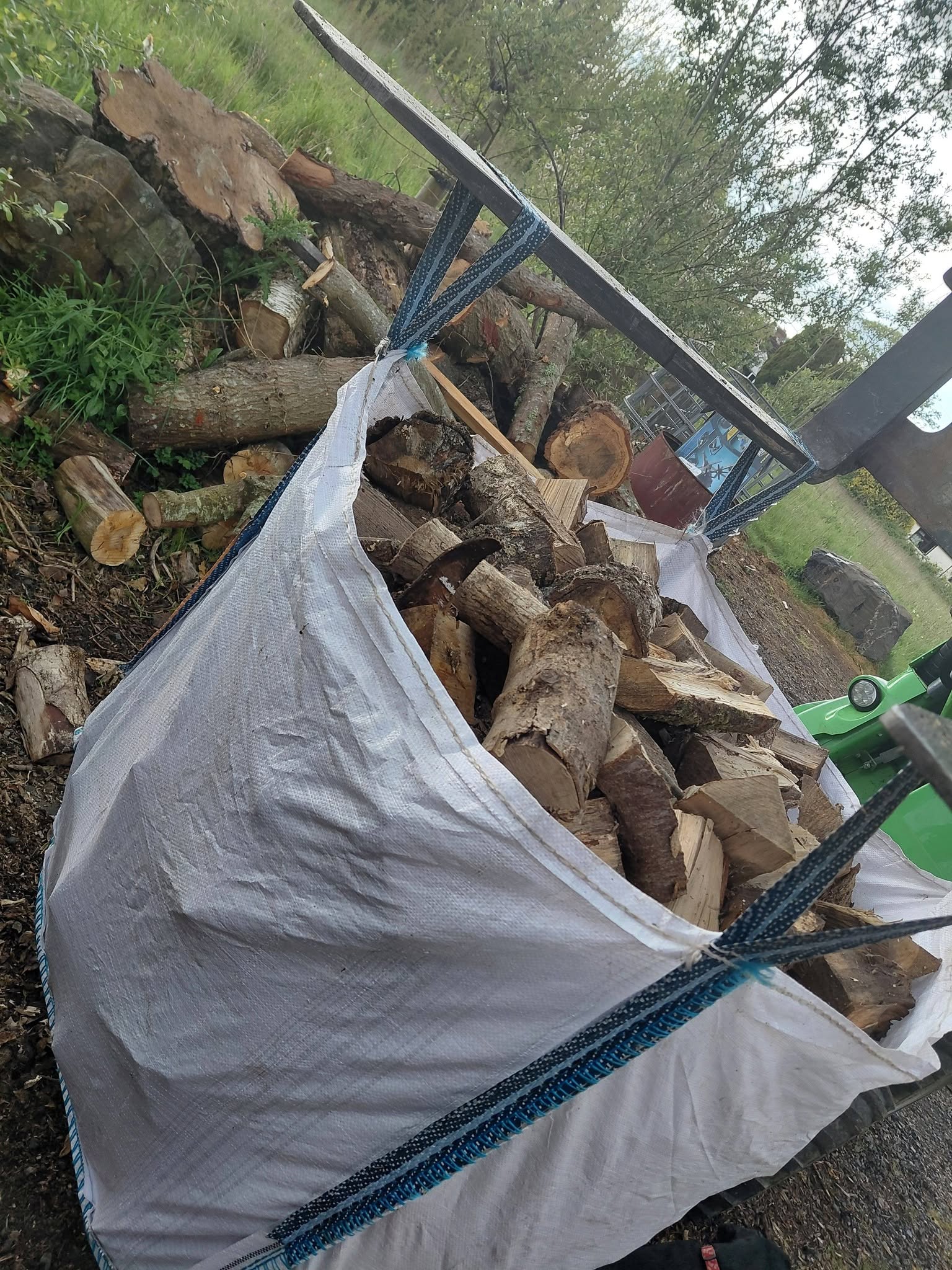 A bulk bag full of split hardwood logs