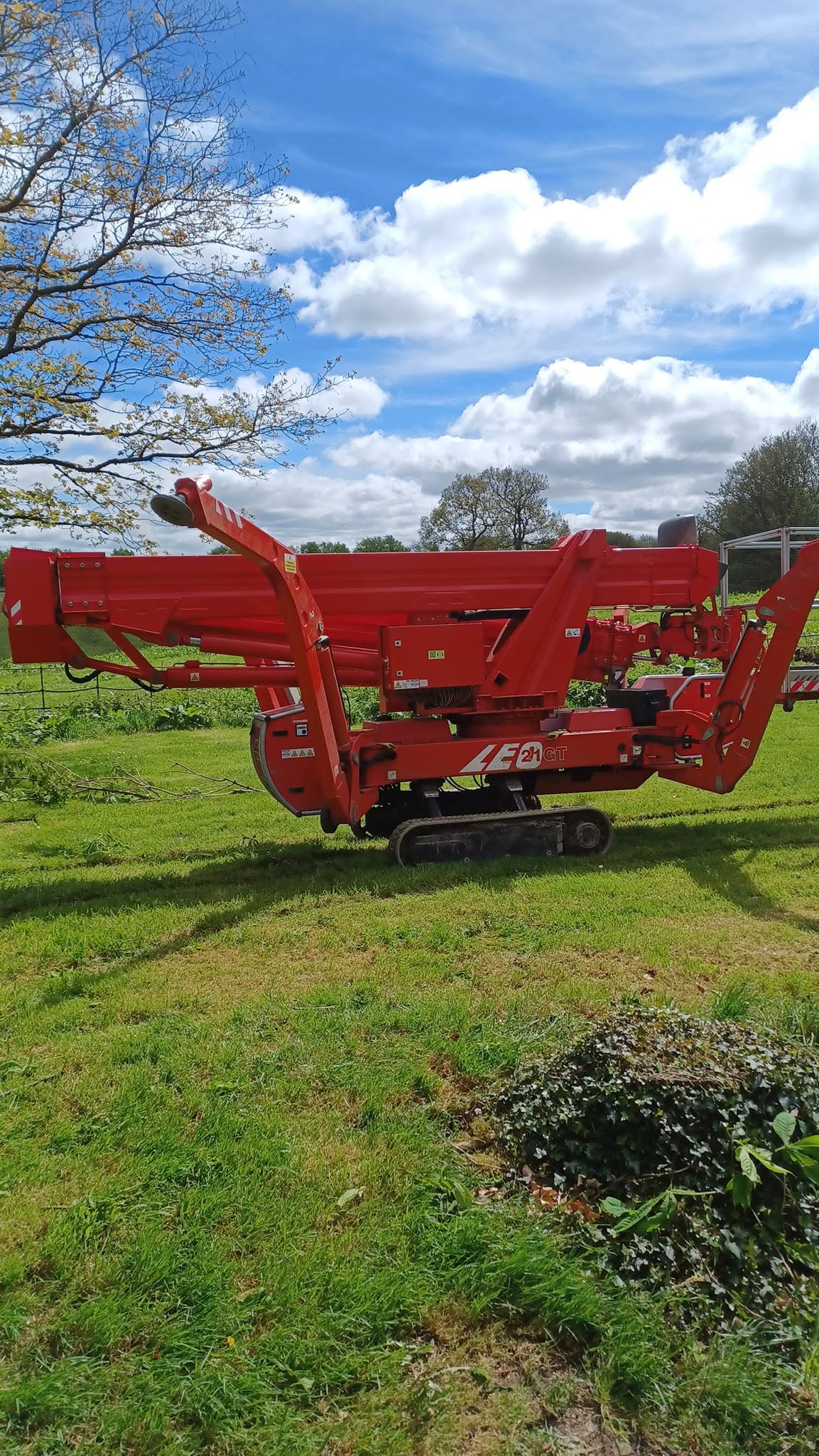 Big Red folded down on its tracks in a field